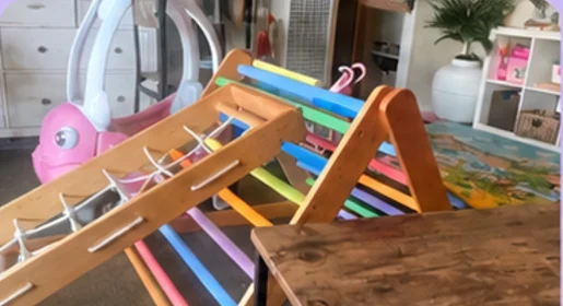 A wooden rainbow climbing triangle and ramp